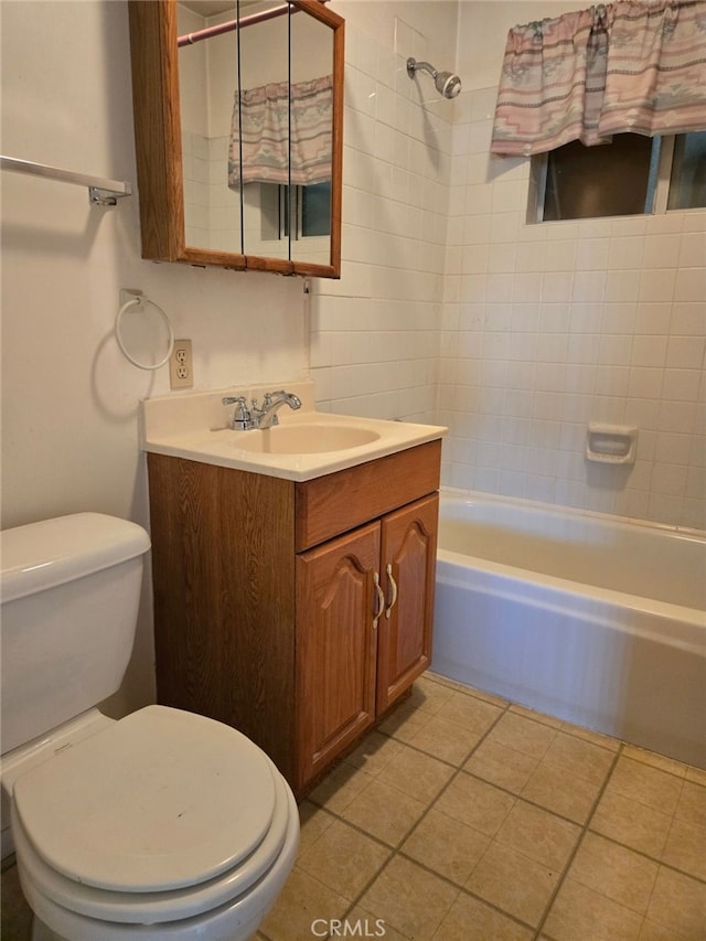 full bathroom with toilet, vanity, tile patterned floors, and tiled shower / bath