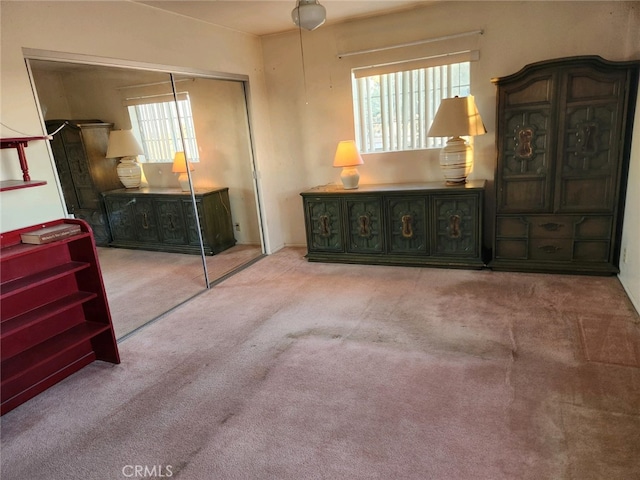 carpeted bedroom with multiple windows and a closet