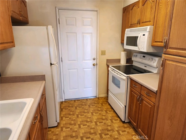 kitchen featuring white appliances and sink