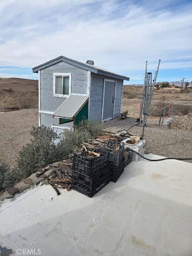 exterior space with a patio area and an outbuilding