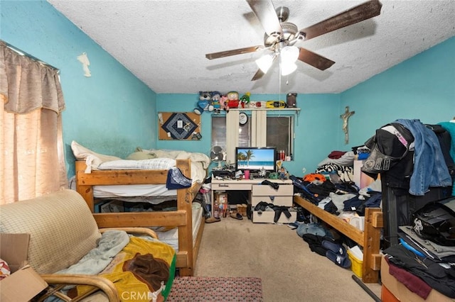 bedroom featuring carpet, ceiling fan, and a textured ceiling