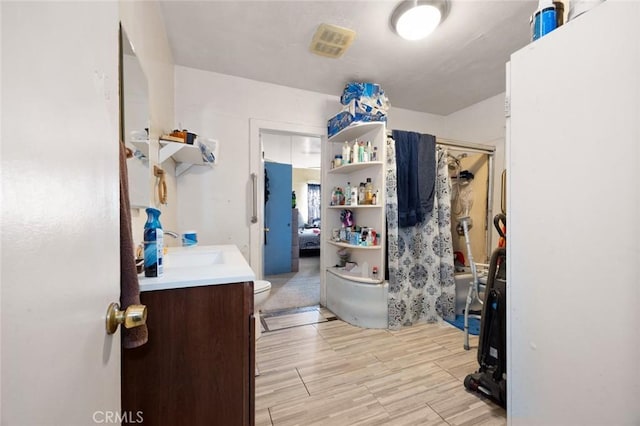 full bathroom featuring hardwood / wood-style floors, vanity, toilet, and tub / shower combination