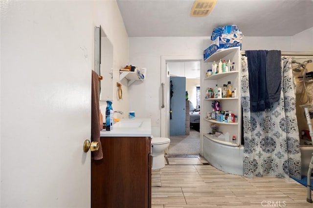 bathroom featuring hardwood / wood-style floors, vanity, and toilet