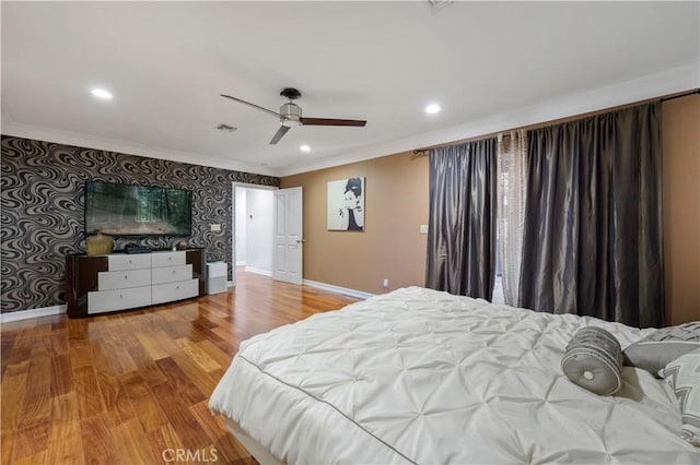 bedroom featuring wood-type flooring, ceiling fan, and crown molding