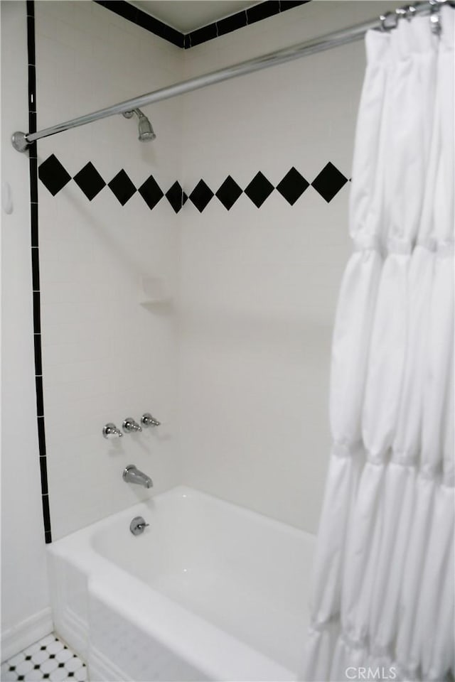 bathroom with shower / tub combo with curtain and tile patterned flooring