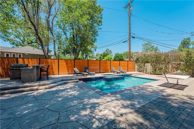 view of swimming pool featuring an outdoor bar, an in ground hot tub, and a patio