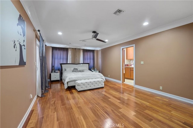 bedroom with ceiling fan, crown molding, and light hardwood / wood-style floors