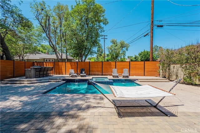 view of pool with an in ground hot tub and a patio area