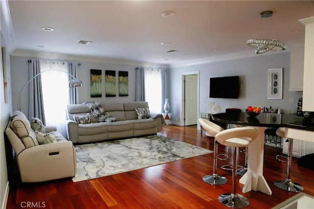 living room with wood-type flooring and an inviting chandelier