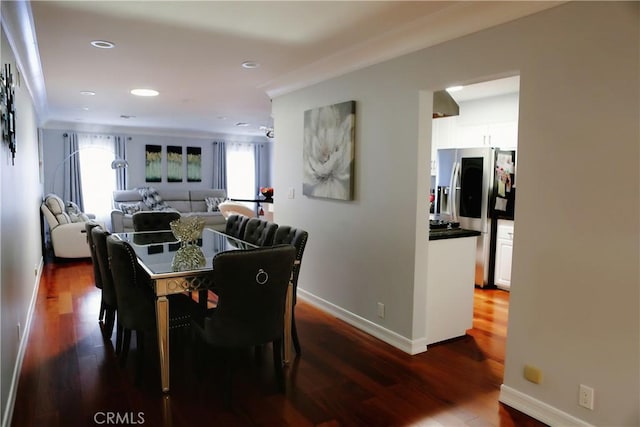 dining space with dark hardwood / wood-style flooring