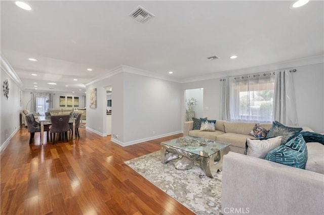 living room featuring wood-type flooring and ornamental molding