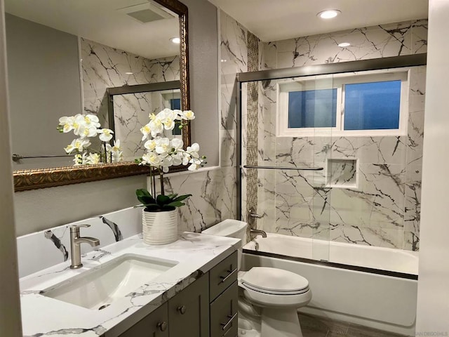 full bathroom with vanity, toilet, and combined bath / shower with glass door