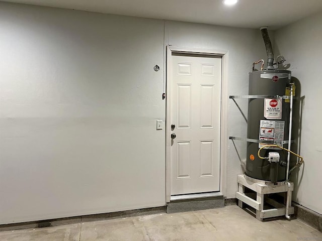 interior space featuring water heater and concrete flooring