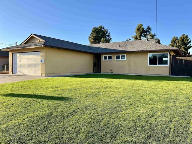 ranch-style house with a garage and a front lawn