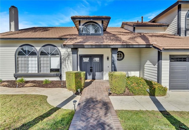 exterior space with a front yard and a garage