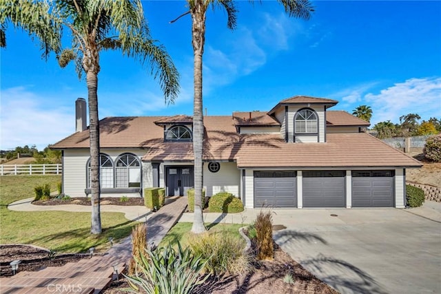 view of property with a front yard and a garage