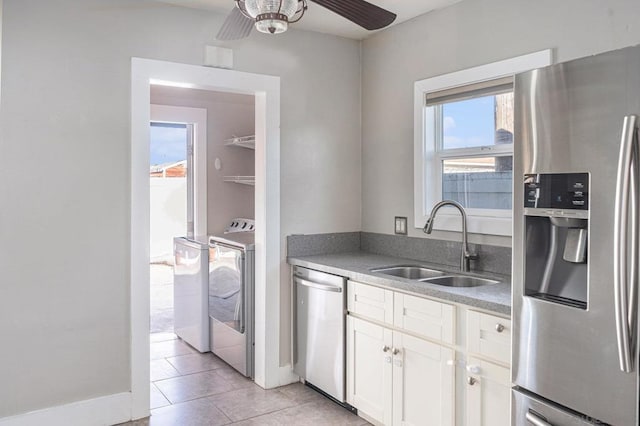 kitchen featuring white cabinets, sink, ceiling fan, light tile patterned floors, and stainless steel appliances