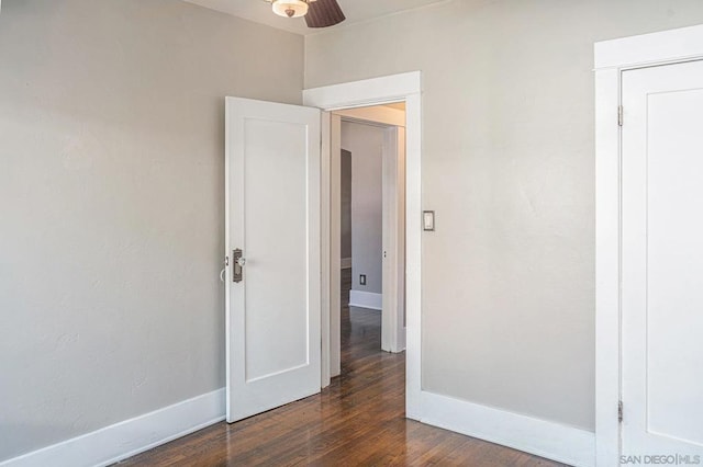 spare room with ceiling fan and dark hardwood / wood-style flooring