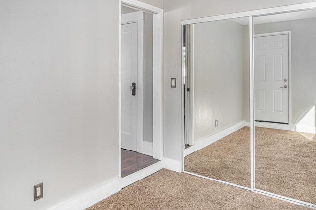 unfurnished bedroom with carpet flooring and a closet