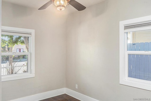 spare room with ceiling fan and dark hardwood / wood-style flooring