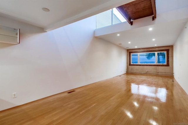 unfurnished living room featuring plenty of natural light and light hardwood / wood-style flooring