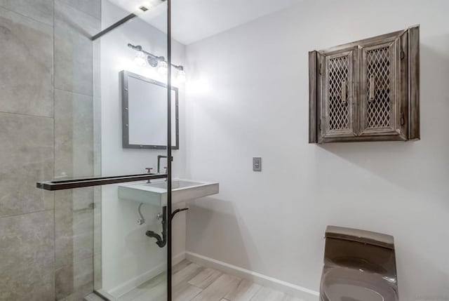 bathroom featuring hardwood / wood-style flooring and a shower with shower door