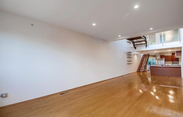 unfurnished living room with light hardwood / wood-style flooring