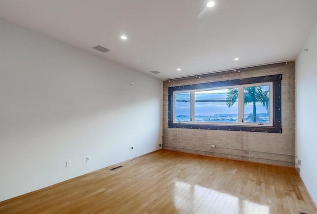 spare room featuring light wood-type flooring