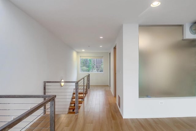 corridor with light hardwood / wood-style flooring