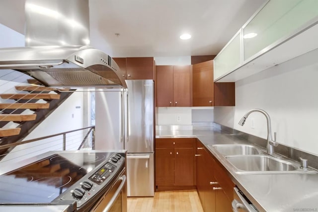 kitchen featuring stainless steel counters, sink, light hardwood / wood-style floors, stainless steel electric stove, and island range hood