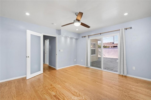 spare room featuring ceiling fan, french doors, and light wood-type flooring