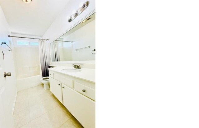 full bathroom with tile patterned flooring, vanity, toilet, and shower / bath combo with shower curtain