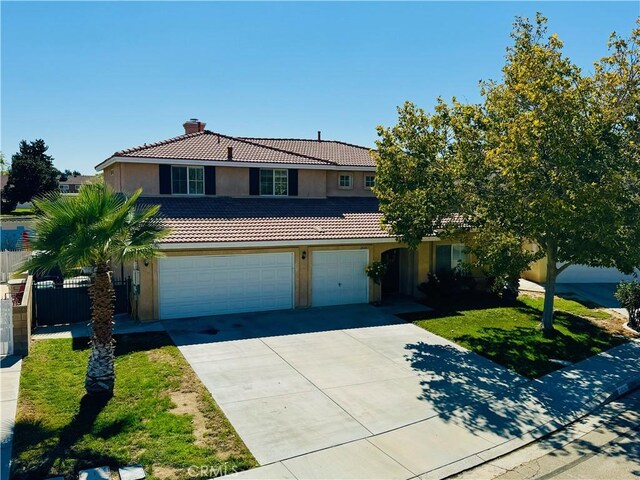 front of property with a garage and a front yard