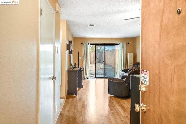 interior space featuring light hardwood / wood-style floors and a textured ceiling