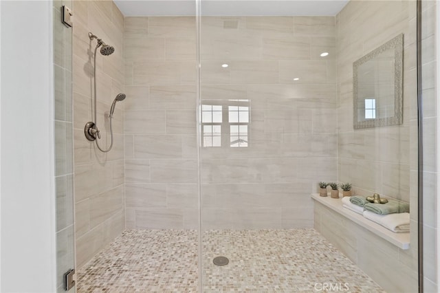 bathroom with a shower with shower door