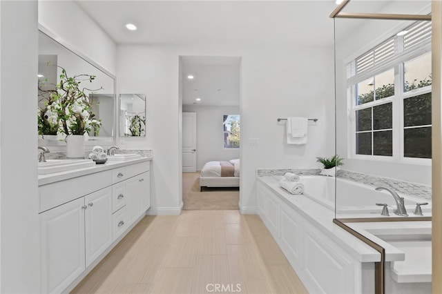 bathroom with vanity and a bath