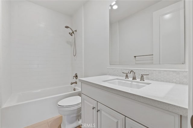 full bathroom featuring decorative backsplash, vanity, tile patterned flooring, toilet, and tiled shower / bath