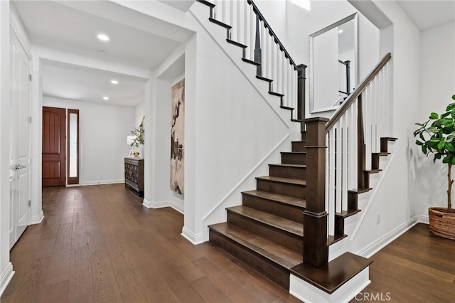 stairs featuring hardwood / wood-style flooring