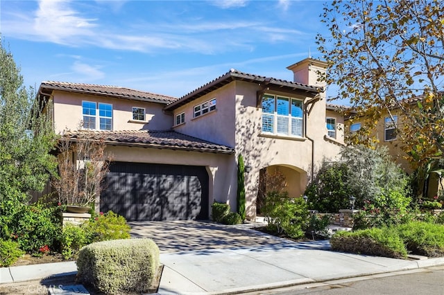 mediterranean / spanish house featuring a garage