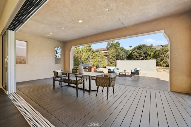 deck featuring a patio area and an outdoor hangout area