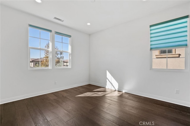 spare room with dark hardwood / wood-style floors