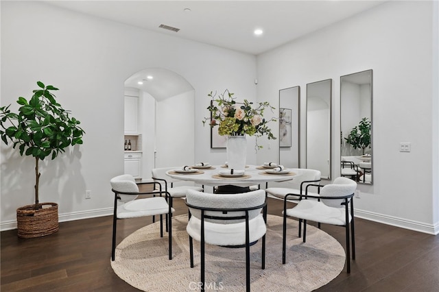 dining space with dark hardwood / wood-style flooring