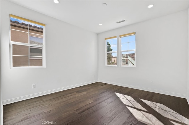 unfurnished room featuring dark wood-type flooring