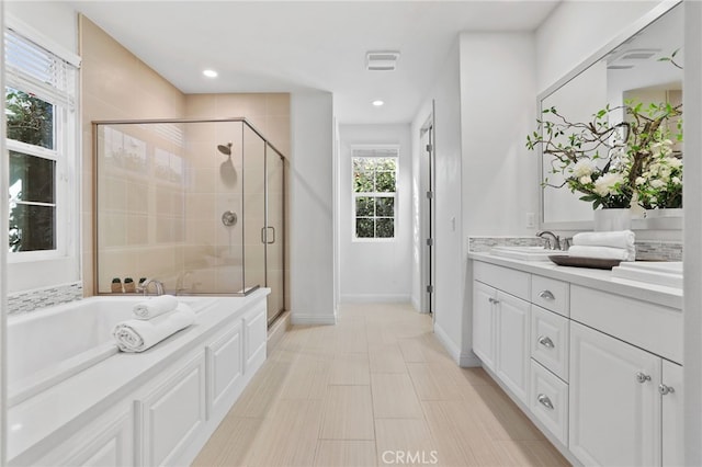 bathroom featuring vanity and plus walk in shower