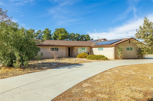 single story home featuring solar panels