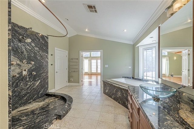 bathroom featuring tile patterned flooring, tiled tub, lofted ceiling, vanity, and ornamental molding