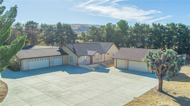 ranch-style home featuring a mountain view and a garage