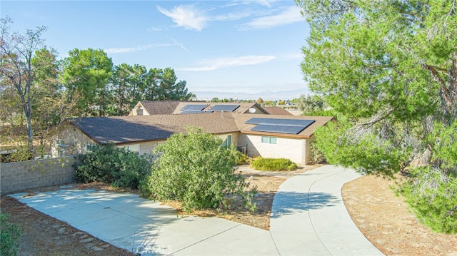 view of front of property featuring solar panels