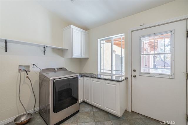 washroom with cabinets and washer / clothes dryer