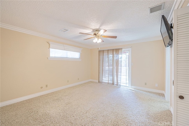 carpeted spare room with ceiling fan, crown molding, and a textured ceiling